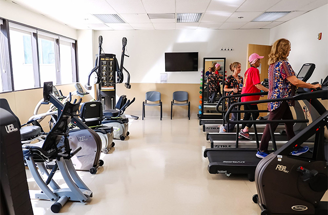 Patients walking on treadmills in the cardiac rehab center.